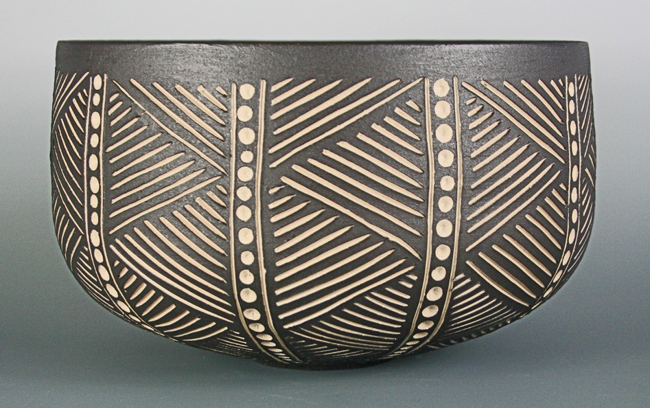 white stoneware bowl with incised black slip and white glaze